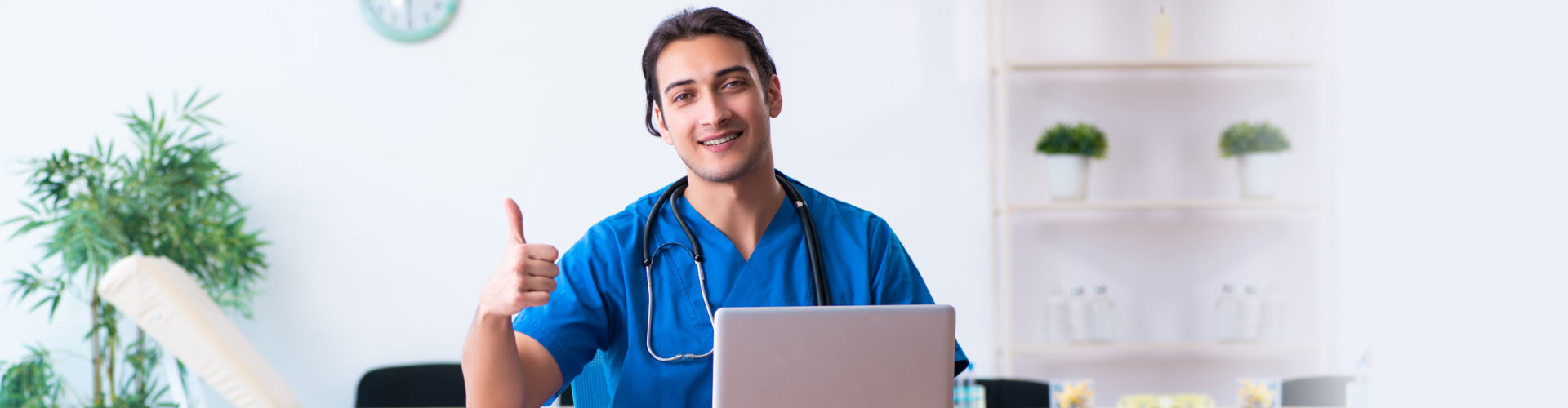 a male nurse on a laptop